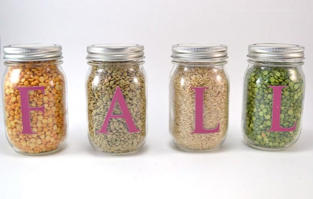 Mason jars are filled with a bounty of dried goods and dusted with gold for a beautiful table display!