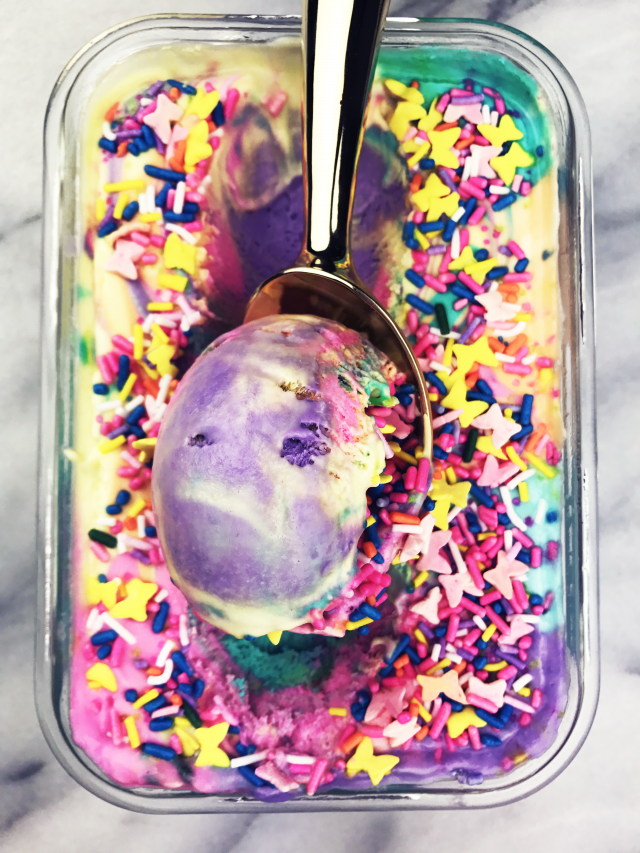 Rainbow Unicorn Ice Cream Recipe - Unicorns may be imaginary magical creatures, but we're still ready to celebrate them. Today's recipe does just that. It's a mixture of bright rainbow ice cream colors covered in sprinkles. This ice cream recipe is perfect for your next fantasy unicorn party celebration. Or just because it's fun and delicious. Either way. No judgment here.