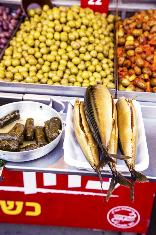 Fish, grape leaves and olives in the markets of Tel Aviv, Israel